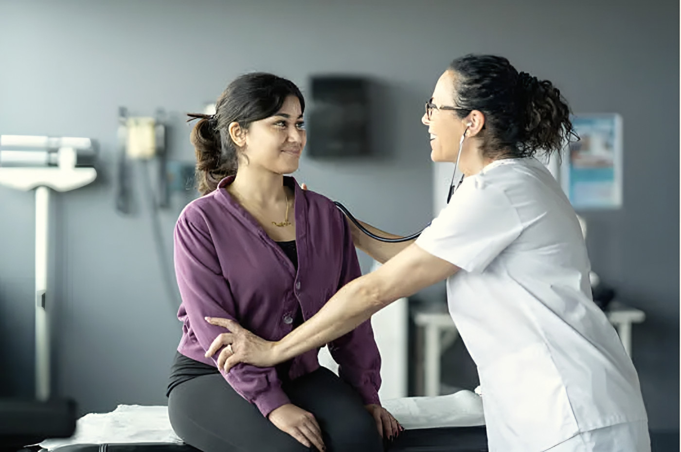 A doctor and patient sharing a smile during a check-up