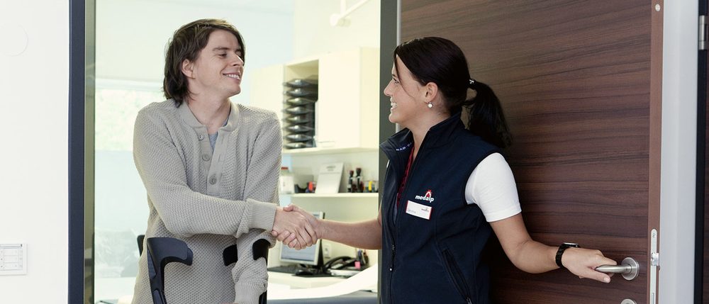 A patient being welcomed at the front desk
