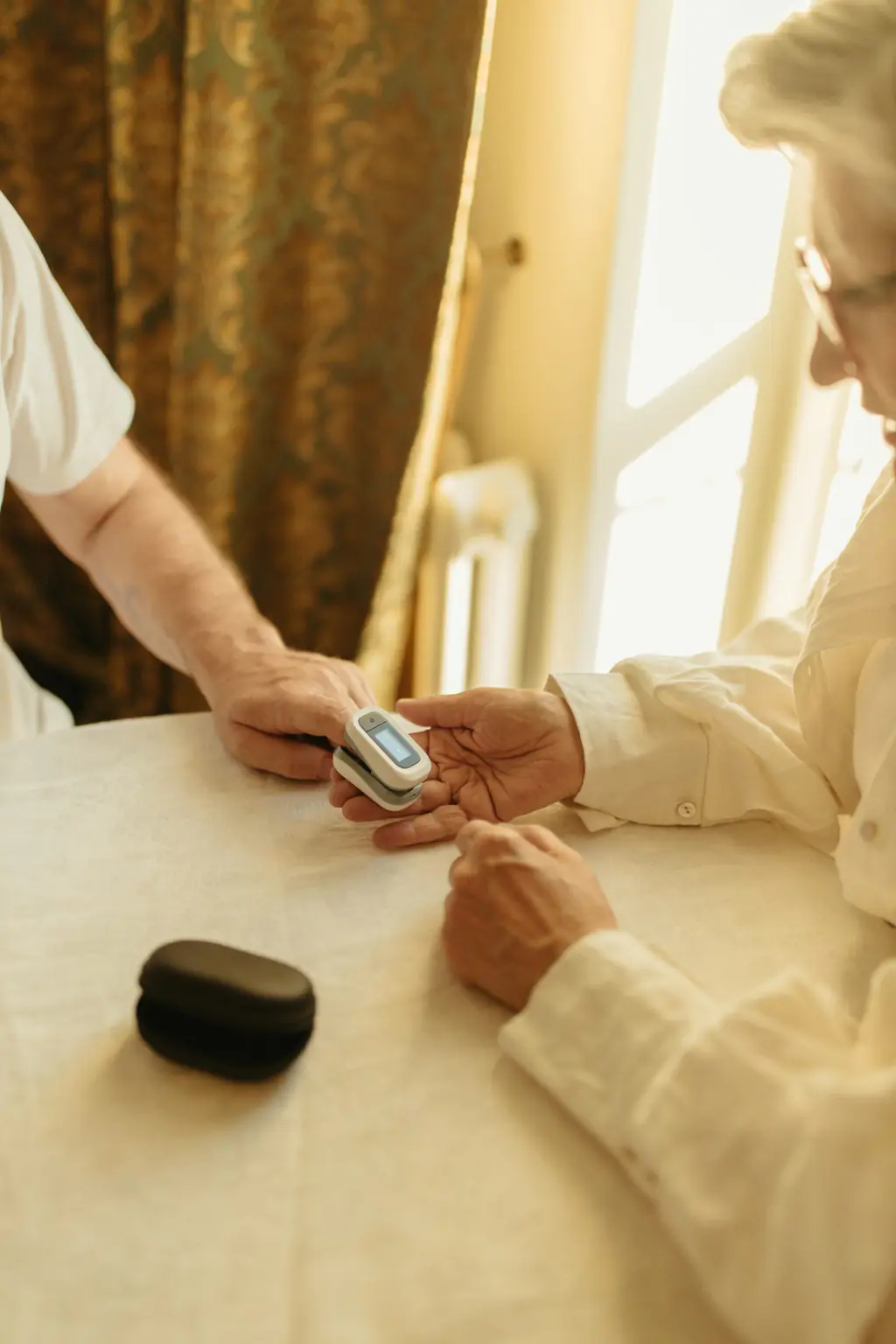 A clinician checking a patient's oxygen level with a pulse oximeter